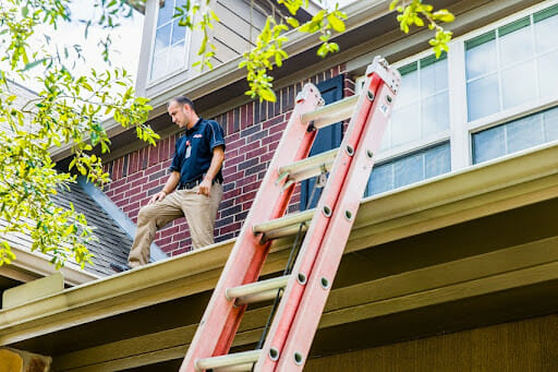 John Moore Services technician looking at a roof renovation.